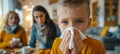 Closeup of sick young boy blowing nose into tissue with space for text, illness concept Royalty Free Stock Photo