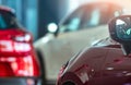 Closeup side mirror of red car on blurred SUV parked in modern showroom. Car dealership. Auto leasing concept. Car stock in Royalty Free Stock Photo