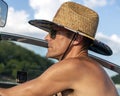 Closeup side view of a forty-four year-old Caucasian man driving a ski boat on Grand Lake in Oklahoma.