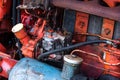 Closeup side view of old tractor engine red rusty vintage abstract detail with sharp selective focus grease aged Royalty Free Stock Photo