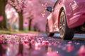 closeup side view of pink car tire on spring street with sakura cherry blossoms in the background