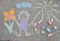 Closeup of a sidewalk chalk art with colorful childish drawings