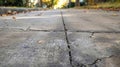 A closeup of a sidewalk reveals deep grooves where chunks of hail have pelted the concrete leaving behind deep craters Royalty Free Stock Photo