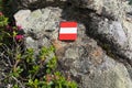 Closeup sign hiking trail rock alpine roses