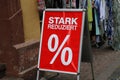 Closeup of signage with the German words Stark Reduziert % - Translation: Greatly Reduced