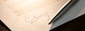 Closeup of signature and silver ballpoint pen with on document. Focus on signature Royalty Free Stock Photo