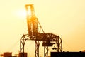 Closeup and Silhouette of container crane are loading containers from cargo ship Royalty Free Stock Photo