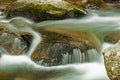 Closeup silky water falling over rocks. Royalty Free Stock Photo