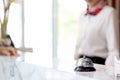 Closeup of silver bell ring on hotel reception service desk with receptionist service customer at hotel counter desk as blurred Royalty Free Stock Photo