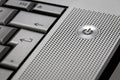 Closeup of silver computer laptop selective focus on standby on button ideal for technology business start power symbol