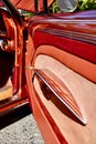 Closeup of silver engraved back end of a Classic 1966 Orange Sparkled Chevy IMPALA Car