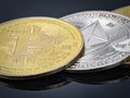 Closeup silver ethereum and gold Bitcoin with reflection