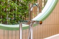 Closeup of silver faucet for Hot water Cold water on a white bathtub with circular windows and trees Royalty Free Stock Photo