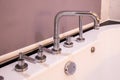 Closeup of silver faucet for Hot water Cold water on a white bathtub Royalty Free Stock Photo