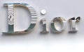 Closeup of the silver logo of a Dior shop