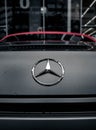 Closeup of a silver Mercedes Bens logo on a car