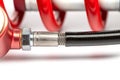 Closeup of a silver and red coil shock absorber other tools in the background Royalty Free Stock Photo