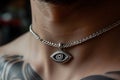 closeup of a silver thirdeye pendant around a neck Royalty Free Stock Photo