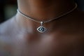 closeup of a silver thirdeye pendant around a neck Royalty Free Stock Photo