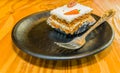 Closeup of single piece of carrot cake decorated with a pecan Royalty Free Stock Photo