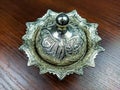 Closeup of a single Turkish oriental copper bowl for storing sugar and sweets with beautiful ornaments and wooden background