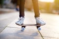 Closeup of skateboarder legs. Kid riding skateboard outdoor.