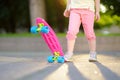 Closeup of skateboarder legs. Kid riding skateboard outdoor.