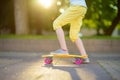 Closeup of skateboarder legs. Kid riding skateboard outdoor.