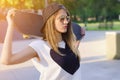 Closeup of skater girl holding skateboard behind her head Royalty Free Stock Photo