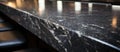 A closeup of a sleek black marble kitchen countertop