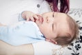 Closeup of Sleeping Newborn Baby in Embraces of His Mum Royalty Free Stock Photo