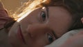 Closeup sleepy girl waking up early morning. Pretty smiling woman resting bed Royalty Free Stock Photo