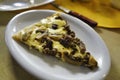 Closeup of a slice of meat pizza in a plate