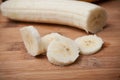 sliced banana on wooden cutting board in bamboo textu