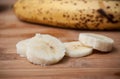 Sliced banana on wooden cutting board in bamboo textu