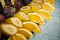 closeup sliced bananas, oranges and grapes on big plate Royalty Free Stock Photo