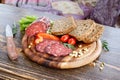 Closeup sliced bread, vegetarian sausage, pepper, tomatoes, arugula on wooden table.