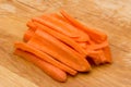 Closeup of sliced carrots placed on wooden cutting board