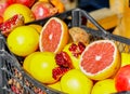 Closeup of sliced colorful fresh fruit, grapefruit and pomegranate at the streetmarket