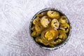 Closeup of sliced pickled jalapeno peppers in bowl and glass jar on table top view Royalty Free Stock Photo