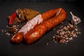 closeup sliced smoked dry sausage with chili and rye bread Royalty Free Stock Photo