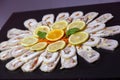 Closeup of sliced stuffed chicken roulade on a plate with orange and lemon slices Royalty Free Stock Photo