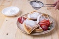 Closeup of sliced waffles with fresh strawberries and sprinkled with powdered sugar Royalty Free Stock Photo