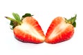 Slices and a half single red strawberry on strawberry leaf Royalty Free Stock Photo