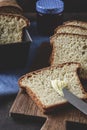 Closeup of slices of homemade white bread with jam on a wooden slat