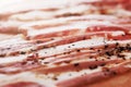 Closeup of slices of smoked pork meat with pepper