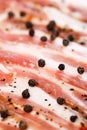 Closeup of slices of smoked pork meat with pepper