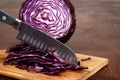 Closeup slicing red cabbage with knife Royalty Free Stock Photo