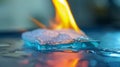 A closeup of a small aerogel sheet being held up against a flame miraculously remaining cool to the touch. In addition