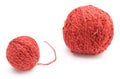 Closeup of small and big red wool ball. White background Royalty Free Stock Photo